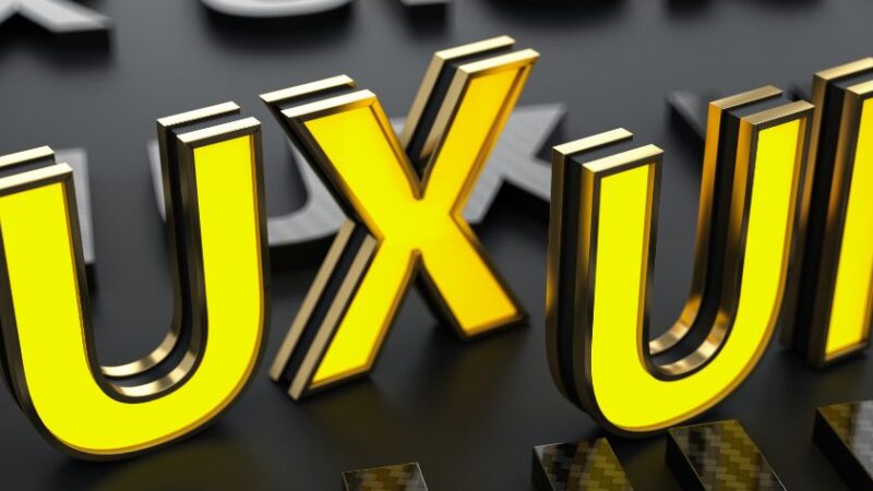 Lettres 3D lumineuses UX en jaune sur fond sombre représentant lexpérience utilisateur