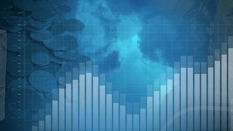 Graphique financier en barres avec piles de pièces et billets de banque en arrière plan