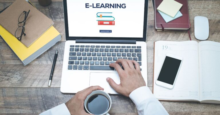 Personne utilisant un ordinateur portable affichant E Learning entouré de livres et dun smartphone